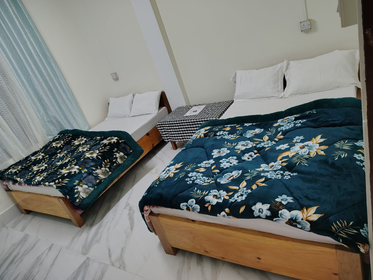 Cozy twin-bed room with floral comforters